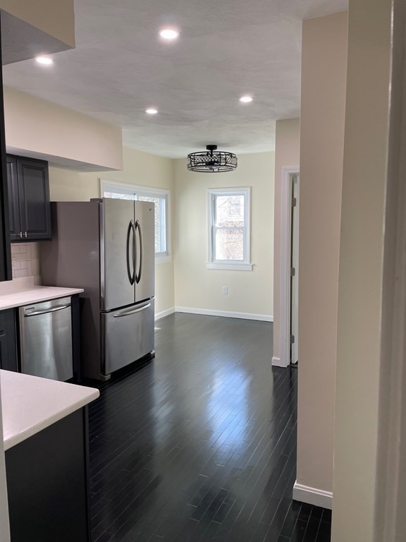 840 South Street, Unit 1 Boston, MA 02131 - Photo 3 of 19 a view of a refrigerator in kitchen and wooden floor