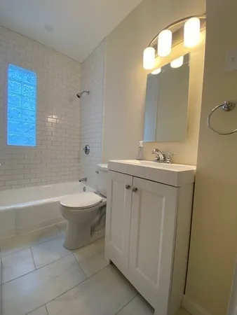 a bathroom with a sink a toilet and bathtub