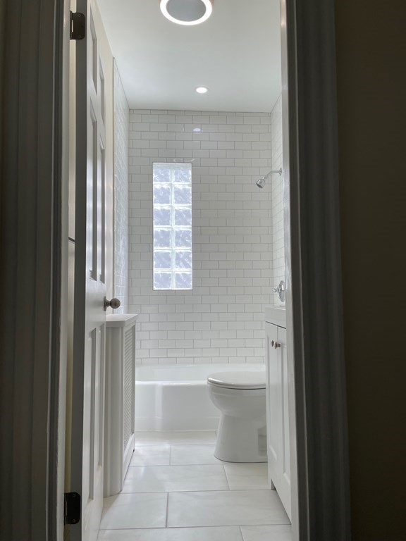 840 South Street, Unit 1 Boston, MA 02131 - Photo 10 of 19 a bathroom with a bathtub and a shower