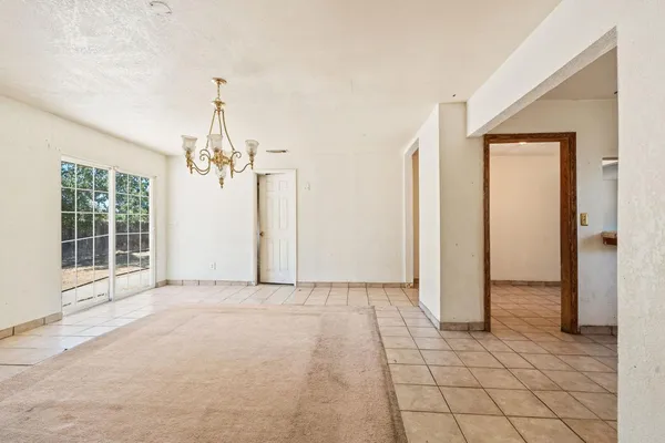 an empty room with windows and entrance