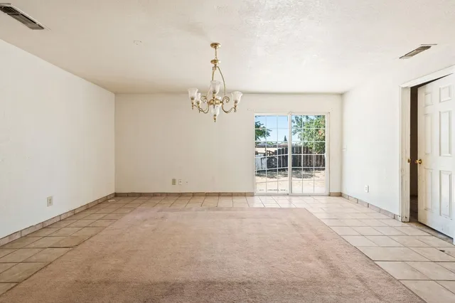 an empty room with windows and entrance