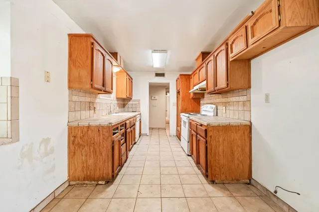a bathroom with stainless steel appliances granite countertop a large stove and a sink
