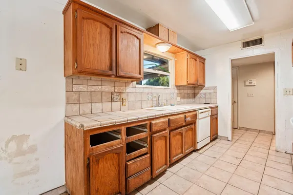 a kitchen with stainless steel appliances granite countertop a sink and cabinets