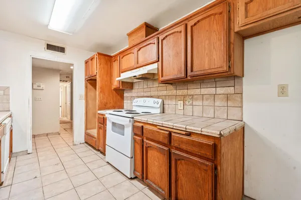 a kitchen with stainless steel appliances granite countertop a stove and a sink