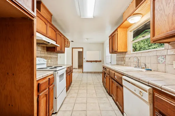 a view of empty room with wooden floor and cabinet
