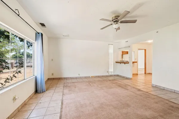 an empty room with white walls and tiles