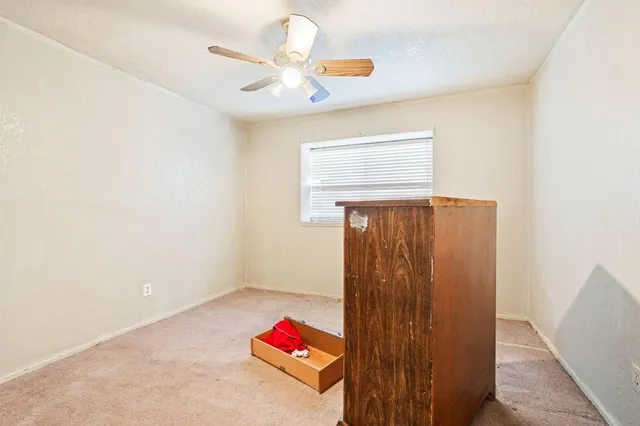a view of room with closet and chandelier fan