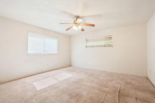a bathroom with a granite countertop sink a toilet and a mirror