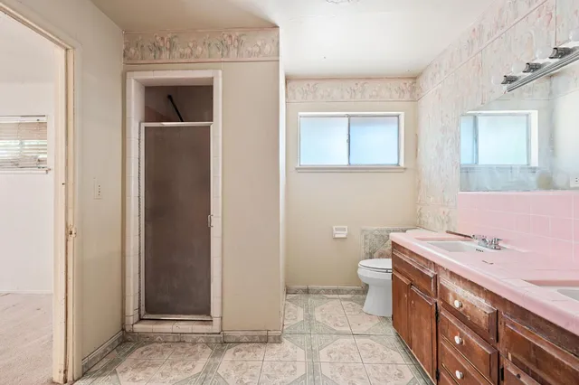 a bathroom with a sink a toilet and mirror