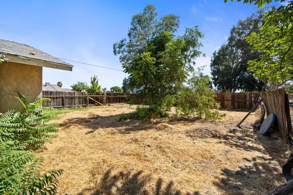 an aerial view of ocean and residential houses with outdoor space