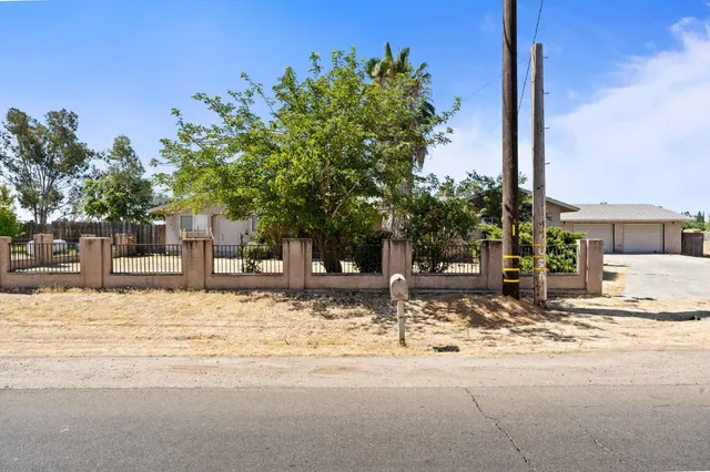 a street sign on a sidewalk next to a road