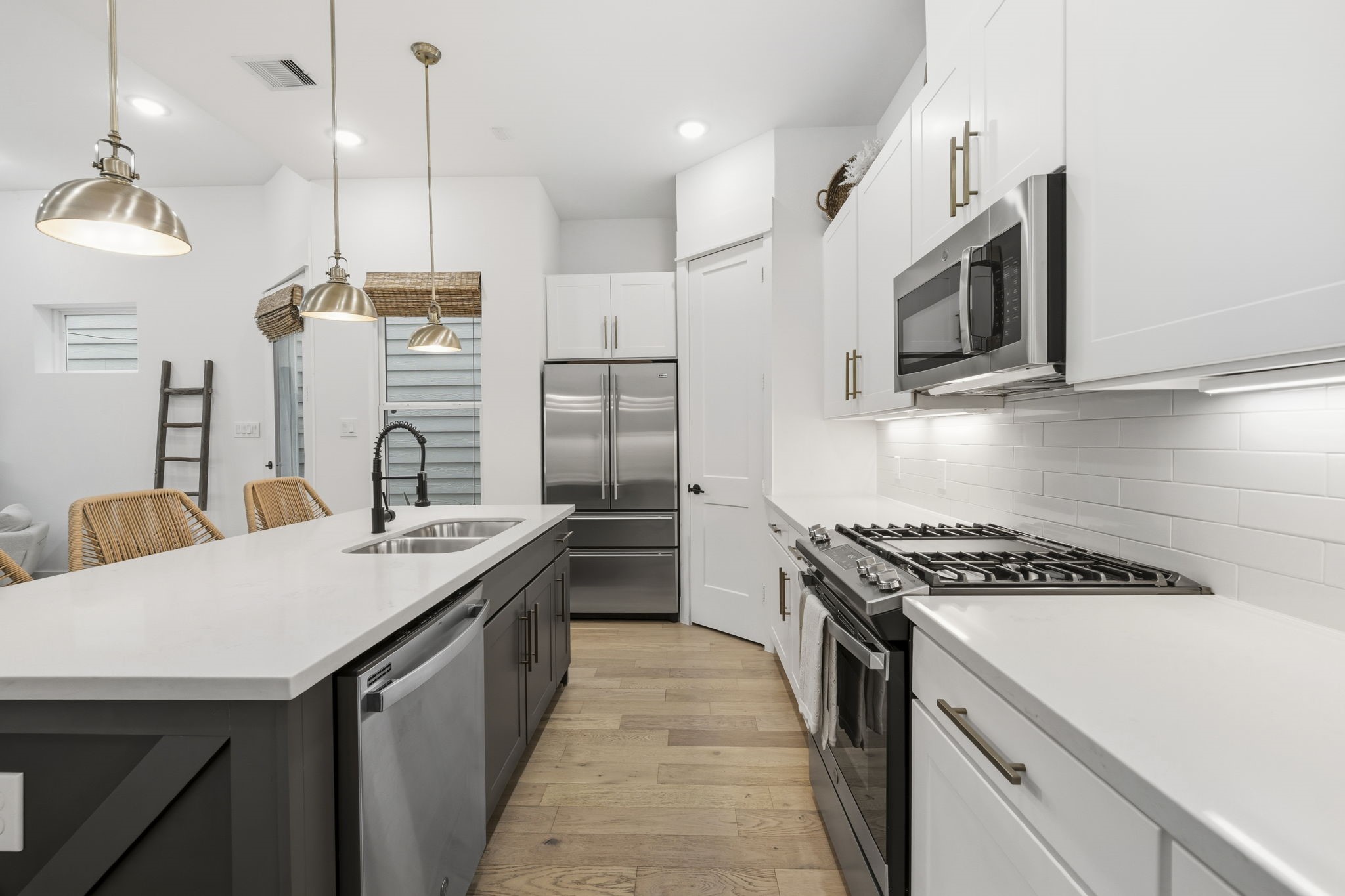 9018 Wellspring Drive Houston, TX 77080 - Photo 7 of 25 Designed for the home chef, the kitchen provides a gas range and built-in microwave, with under-cabinet lighting that illuminates the work surfaces and adds a warm ambiance.
