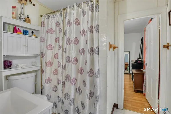 a bathroom with a shower curtain and a sink