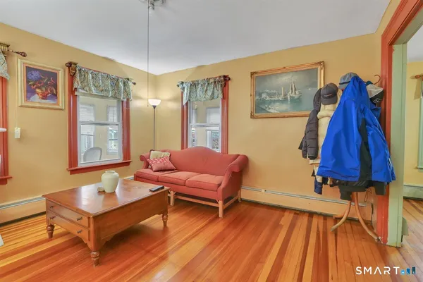 a living room with furniture and a wooden floor