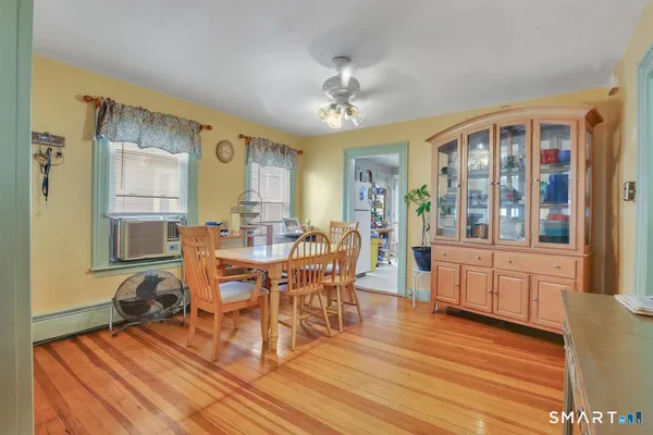 a view of a dining room with furniture window and wooden floor
