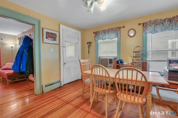 a view of a dining room with furniture and wooden floor