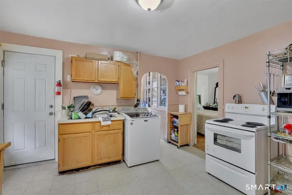 a kitchen with a stove top oven and cabinets