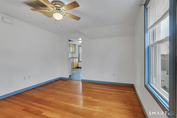 wooden floor in an empty room with a window