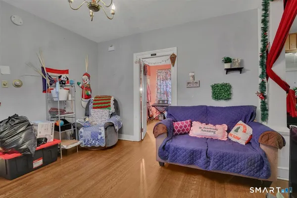 a bedroom with furniture and a wooden floor