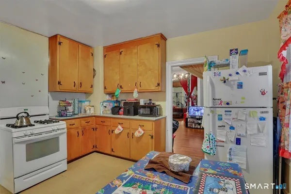 a kitchen with stainless steel appliances a stove a sink and a refrigerator