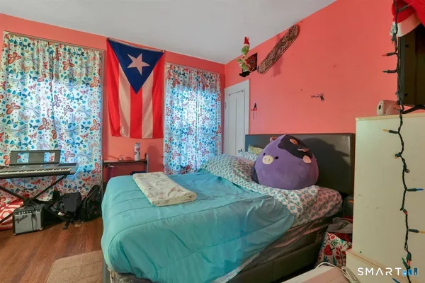 a bedroom with a bed and a window
