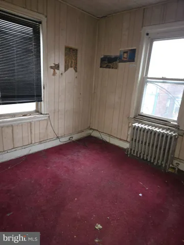 a bathroom with a toilet and a window