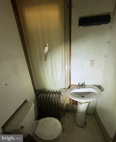 a bathroom with a sink a toilet and mirror