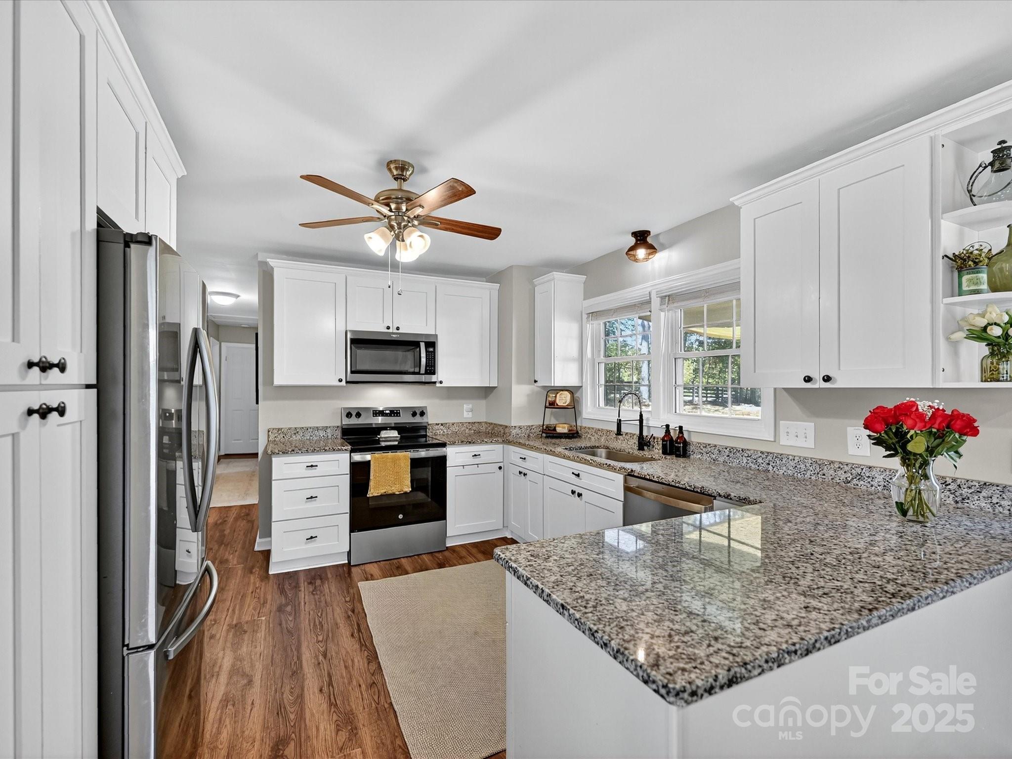 791 Sutton Spring Road York, SC 29745 - Photo 11 of 31 a kitchen with stainless steel appliances granite countertop a refrigerator oven a sink and dishwasher