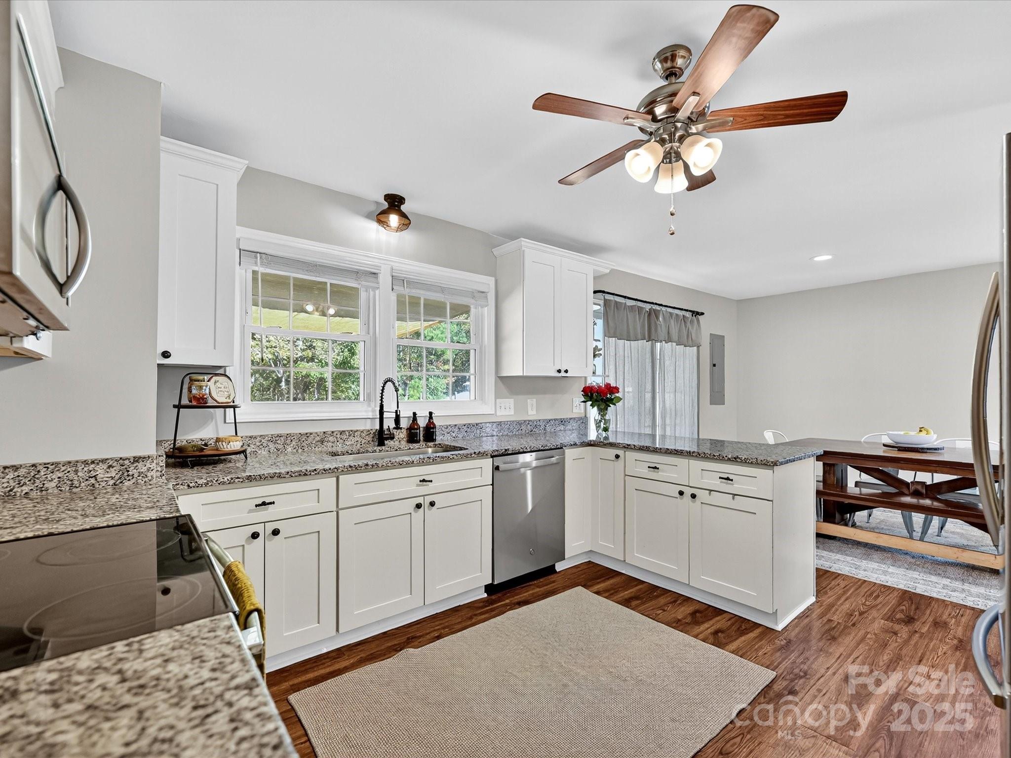 791 Sutton Spring Road York, SC 29745 - Photo 13 of 31 a kitchen with granite countertop a sink stainless steel appliances and cabinets