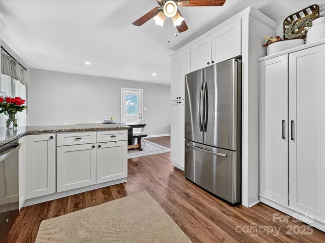 a kitchen with stainless steel appliances a refrigerator sink and cabinets