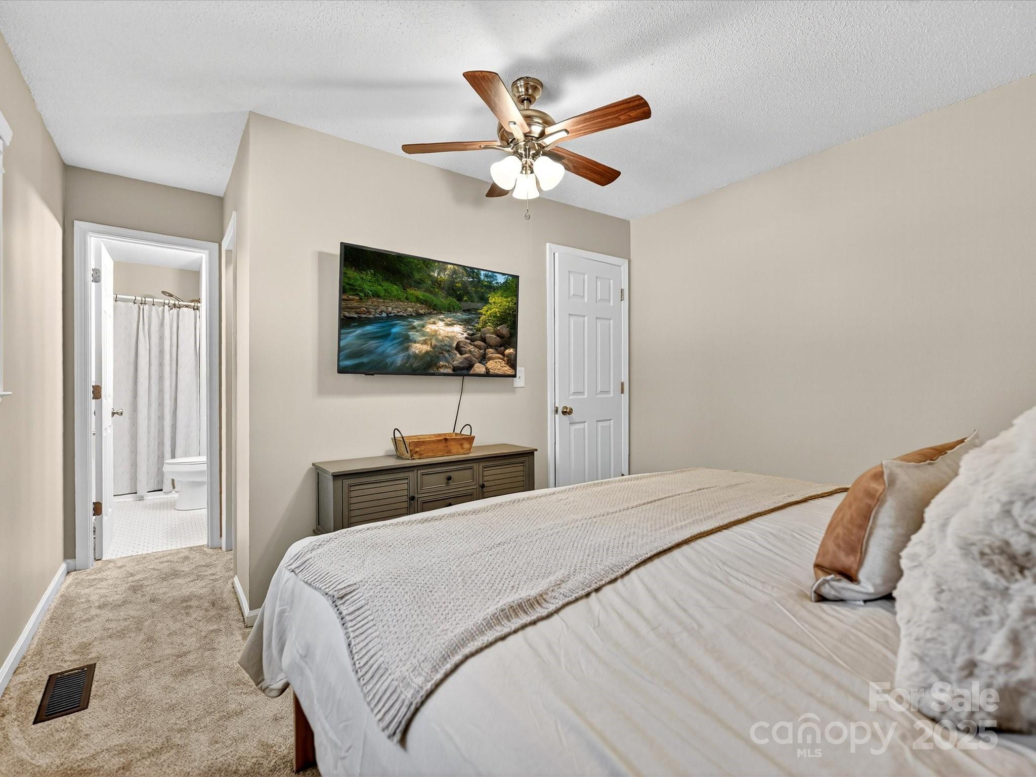 791 Sutton Spring Road York, SC 29745 - Photo 18 of 31 a bedroom with a bed and a flat screen tv