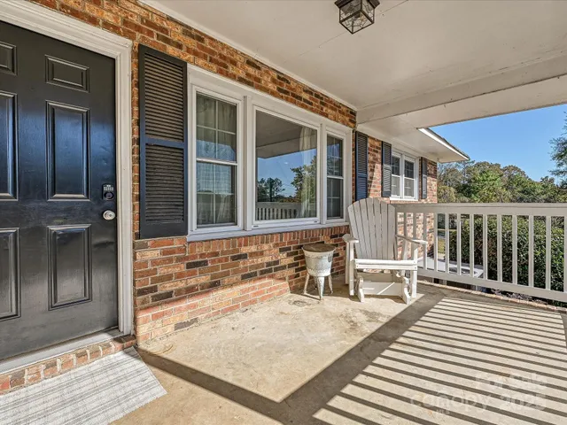 a view of house with deck outdoor seating and kitchen