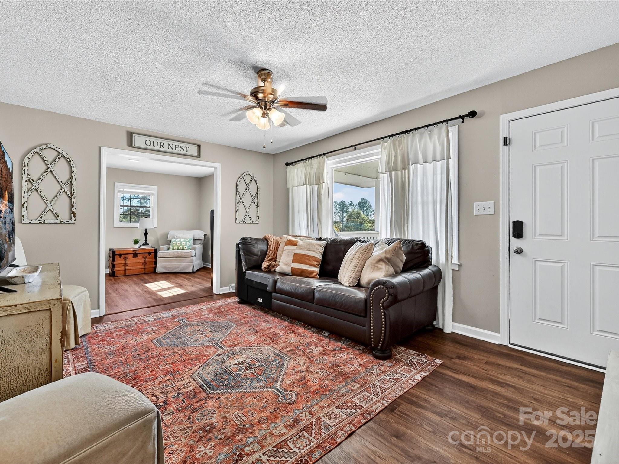 791 Sutton Spring Road York, SC 29745 - Photo 6 of 31 a living room with furniture and a chandelier