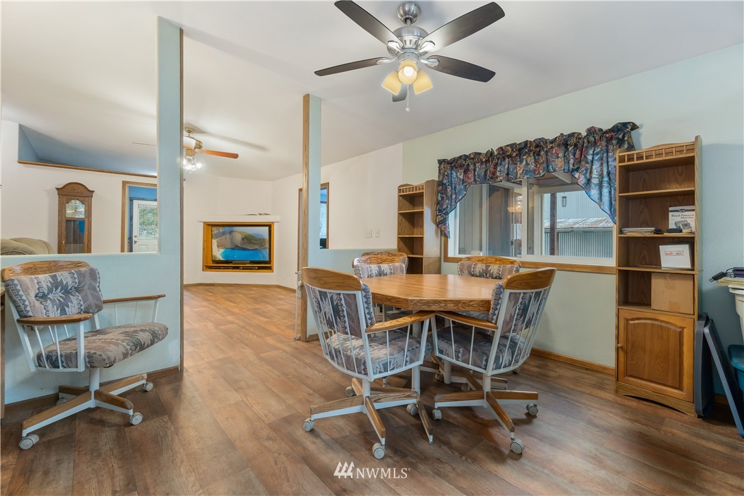 16441 Gibson Road Southwest Tenino, WA 98589 - Photo 14 of 26 a view of a dining room with furniture and a chandelier