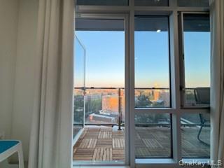 41-62 Bowne Street, Unit 9F Queens, NY 11355 - Photo 18 of 25 a living room with a floor to ceiling window and wooden floor