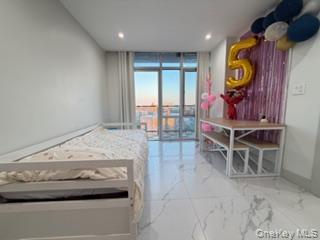 41-62 Bowne Street, Unit 9F Queens, NY 11355 - Photo 19 of 25 a living room with furniture and wooden floor