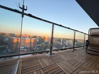 41-62 Bowne Street, Unit 9F Queens, NY 11355 - Photo 20 of 25 a view of a balcony with wooden floor and iron stairs