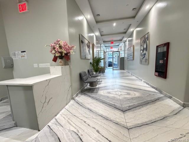 41-62 Bowne Street, Unit 9F Queens, NY 11355 - Photo 6 of 25 a living room with furniture and flowers