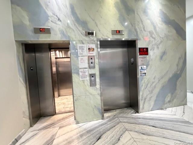41-62 Bowne Street, Unit 9F Queens, NY 11355 - Photo 7 of 25 a kitchen with stainless steel appliances kitchen island a refrigerator and a sink