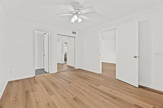 a view of empty room with wooden floor