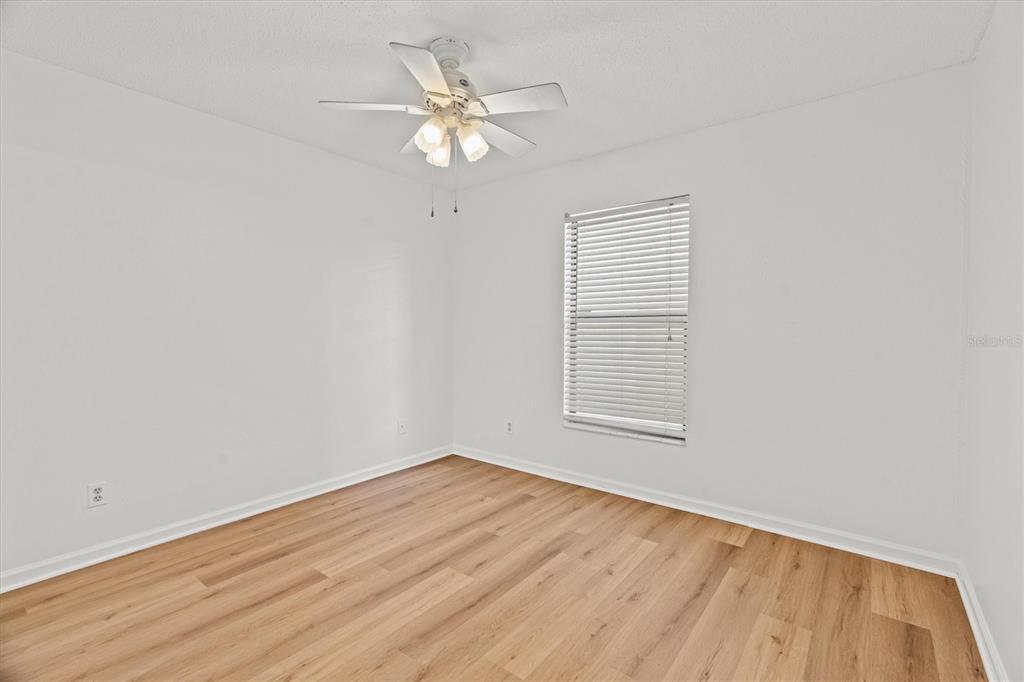 2992 Plaza Terrace Drive, Unit 2992 Orlando, FL 32803 - Photo 15 of 31 an empty room with wooden floor and windows