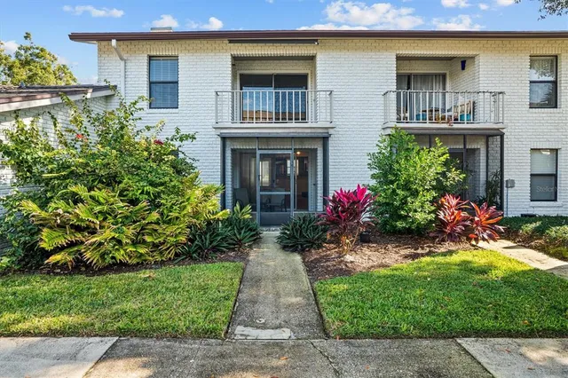 a front view of house and yard with green space