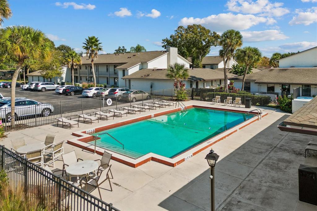 2992 Plaza Terrace Drive, Unit 2992 Orlando, FL 32803 - Photo 22 of 31 a view of a patio with swimming pool table and chairs