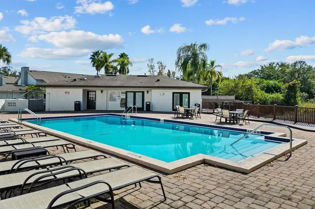a house with swimming pool in front of it