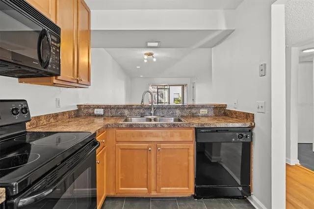 a kitchen with a sink stove and microwave