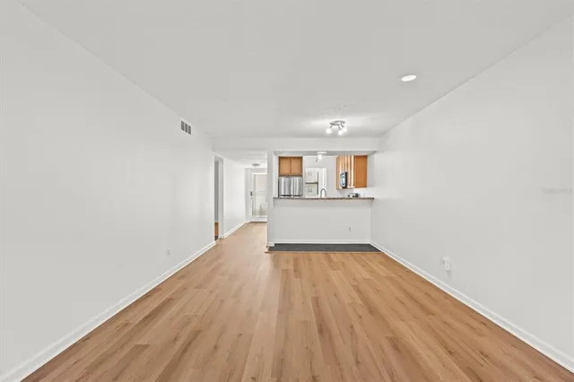 a view of a kitchen with wooden floor and a kitchen