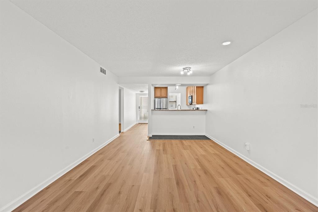 2992 Plaza Terrace Drive, Unit 2992 Orlando, FL 32803 - Photo 7 of 31 a view of a kitchen with wooden floor and a kitchen