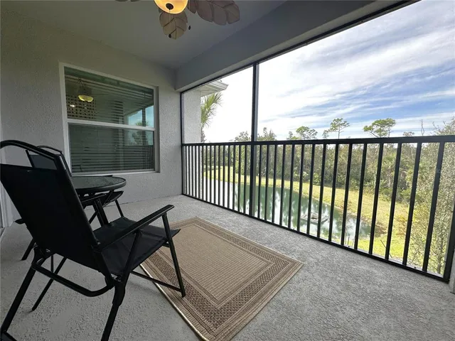 a view of a chairs and table in the balcony
