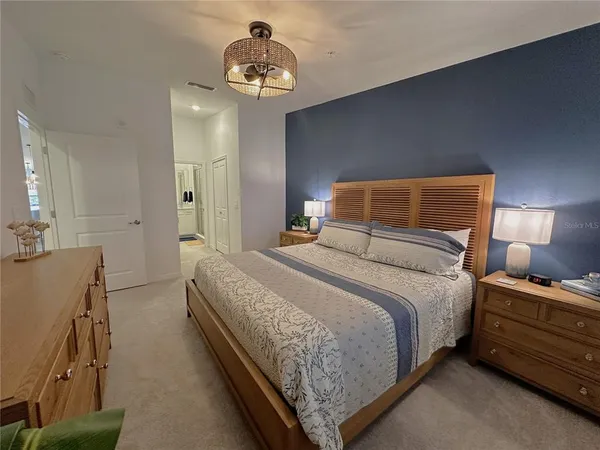 a bedroom with a bed and a chandelier