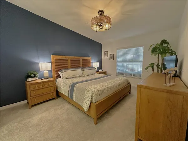 a bedroom with a bed and a chandelier